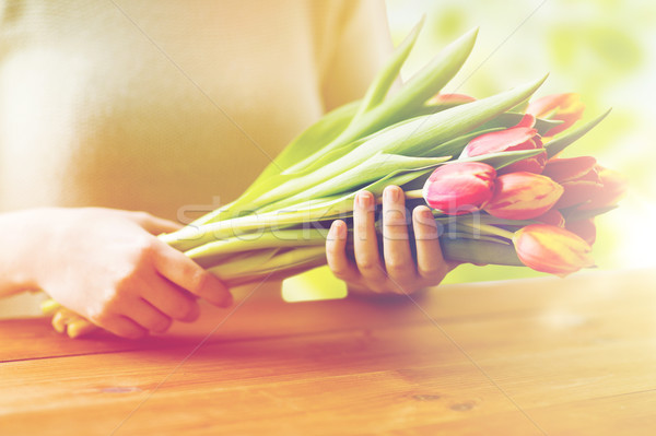 close up of woman holding tulip flowers Stock photo © dolgachov