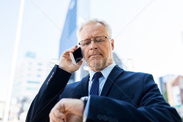senior businessman calling on smartphone in city Stock photo © dolgachov