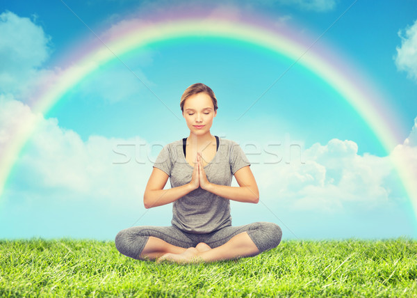 woman meditating in lotus yoga pose over rainbow  Stock photo © dolgachov