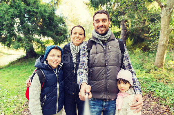 family with backpacks taking selfie and hiking Stock photo © dolgachov