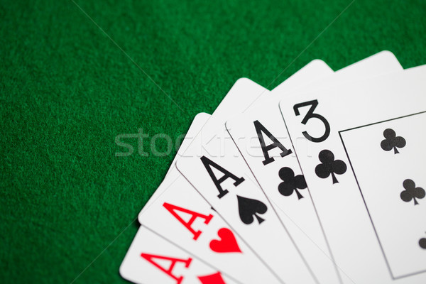 poker hand of playing cards on green casino cloth Stock photo © dolgachov