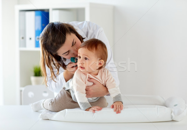 doctor with otoscope checking baby ear at clinic Stock photo © dolgachov
