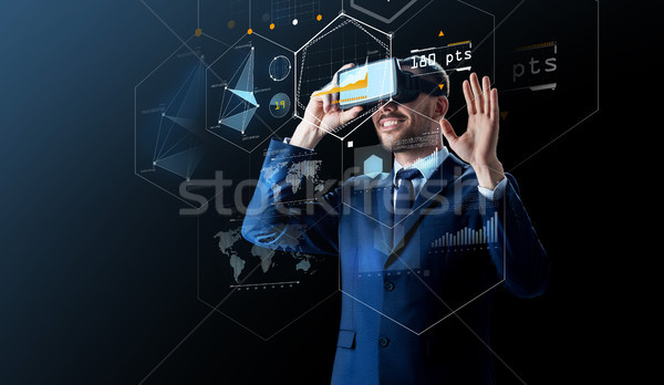 businessman in virtual reality headset over black Stock photo © dolgachov