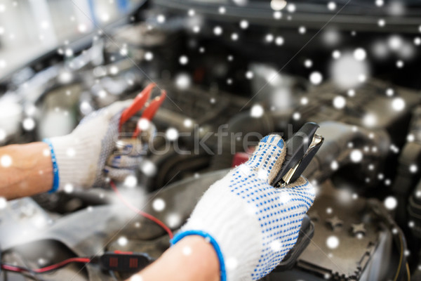 auto mechanic hands with cleats charging battery Stock photo © dolgachov