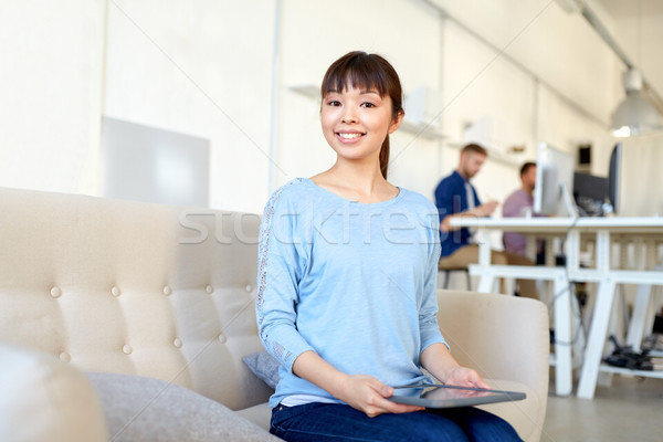 happy asian woman with laptop working at office Stock photo © dolgachov