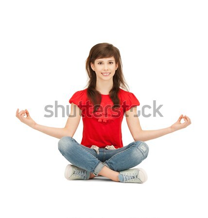 happy and carefree teenage girl in lotus pose Stock photo © dolgachov