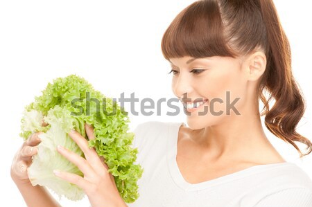 beautiful housewife with lettuce over white Stock photo © dolgachov