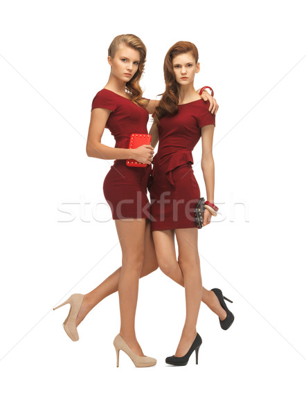 two teenage girls in red dresses with clutches Stock photo © dolgachov