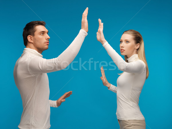 man and woman working with something imaginary Stock photo © dolgachov