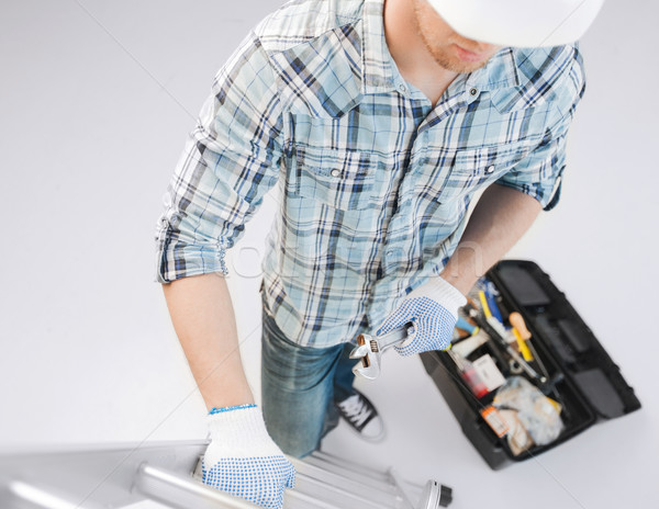 man with ladder, toolkit and spanner Stock photo © dolgachov