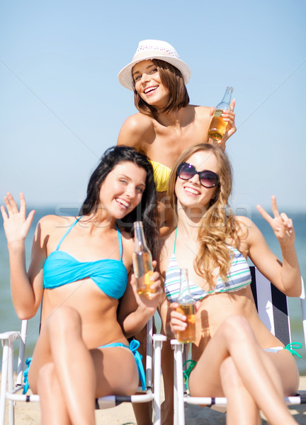 girls with drinks on the beach chairs Stock photo © dolgachov