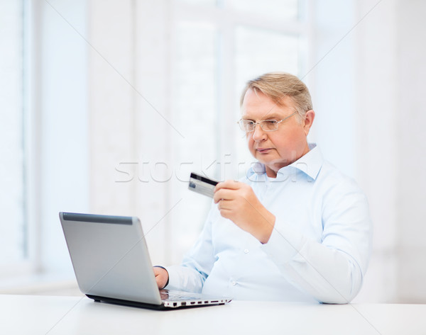 old man with laptop and credit card at home Stock photo © dolgachov