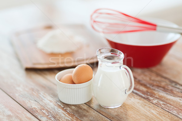 Stock photo: jugful of milk, eggs in a bowl and flour