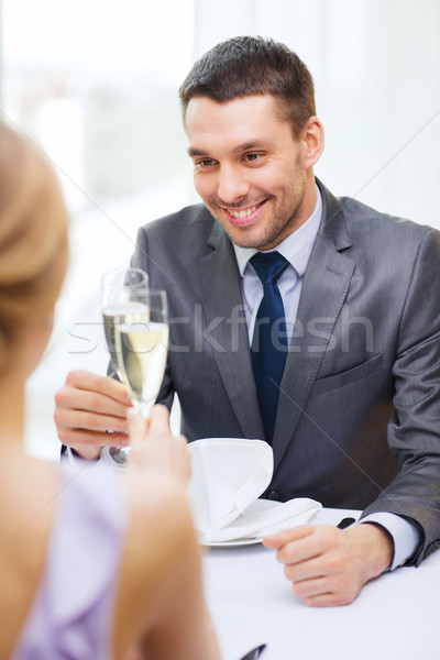 couple with glasses of champagne at restaurant Stock photo © dolgachov