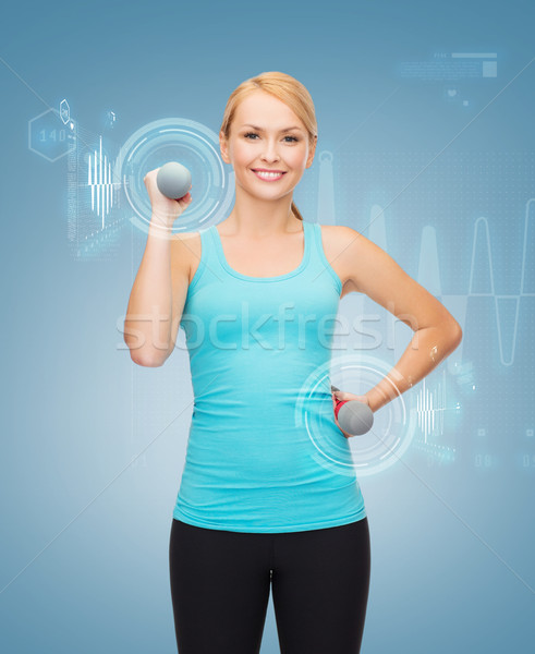 Stock photo: young sporty woman with light dumbbells