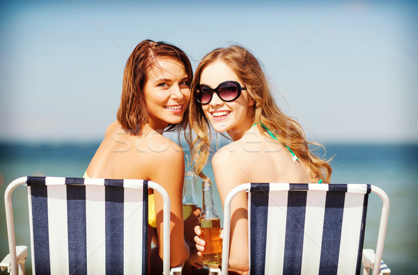 girls with drinks on the beach chairs Stock photo © dolgachov