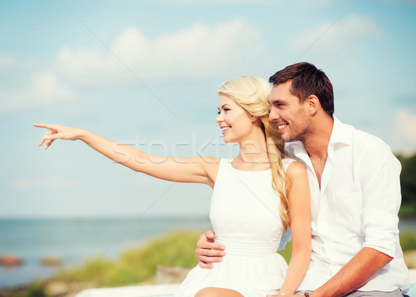 couple sitting at sea side Stock photo © dolgachov