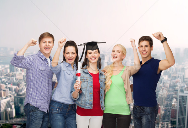 group of standing smiling students with diploma Stock photo © dolgachov
