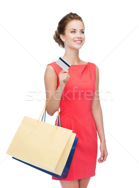 smiling woman with shopping bags and plastic card Stock photo © dolgachov
