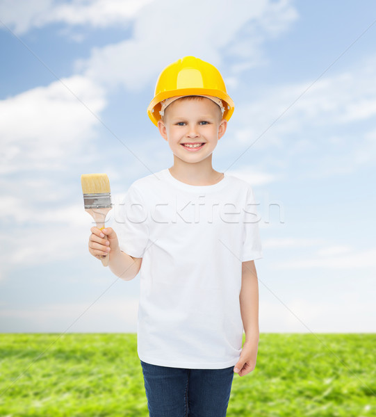 Uśmiechnięty mały chłopca kask pędzlem zawód Zdjęcia stock © dolgachov