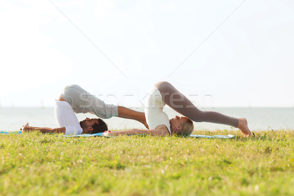 Gülen çift yoga açık havada uygunluk Stok fotoğraf © dolgachov