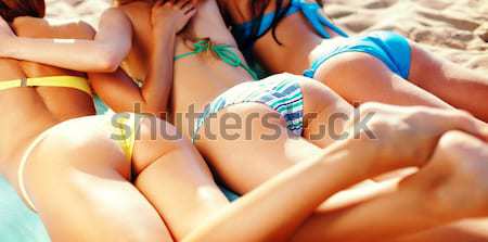 close up of young women lying on beach Stock photo © dolgachov