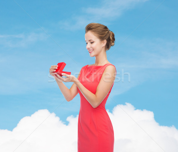 Souriant jeune femme robe rouge coffret cadeau Noël vacances [[stock_photo]] © dolgachov