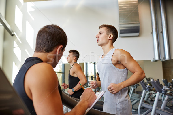 men exercising on treadmill in gym Stock photo © dolgachov