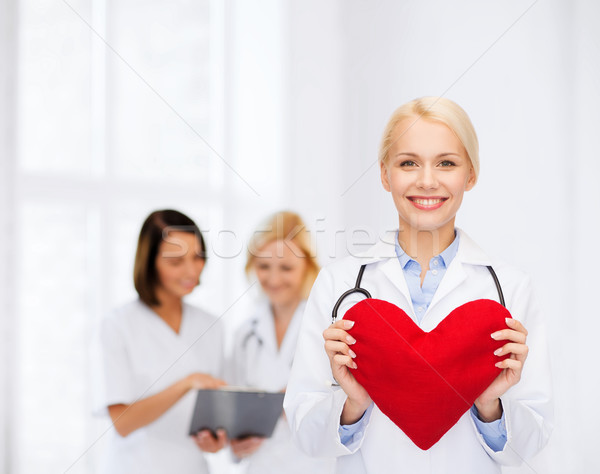 Stock photo: smiling female doctor with heart and stethoscope