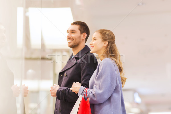 happy young couple with shopping bags in mall Stock photo © dolgachov