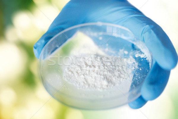 Stock photo: close up of scientist hands holding petri dish