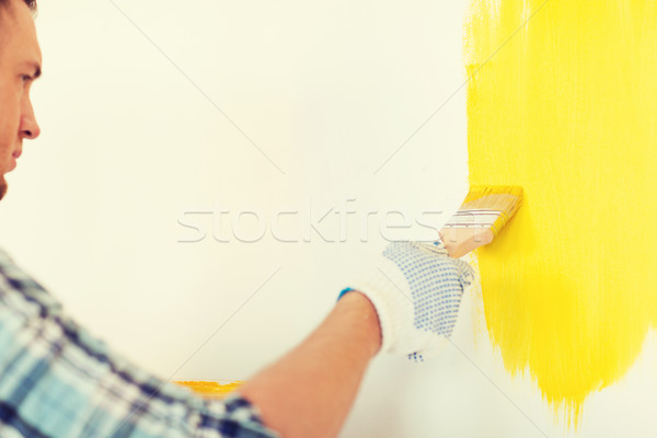 close up of male in gloves holding paintbrush Stock photo © dolgachov