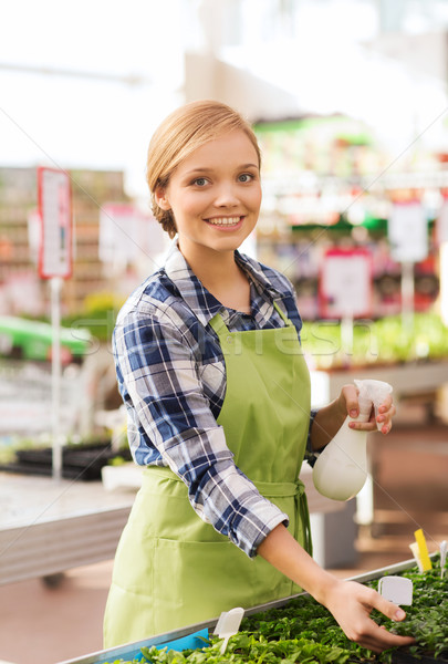 woman with sprayer and seedling in greenhouse Stock photo © dolgachov