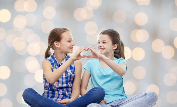 happy little girls showing heart shape hand sign Stock photo © dolgachov