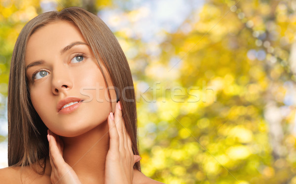 beautiful young woman touching her neck Stock photo © dolgachov