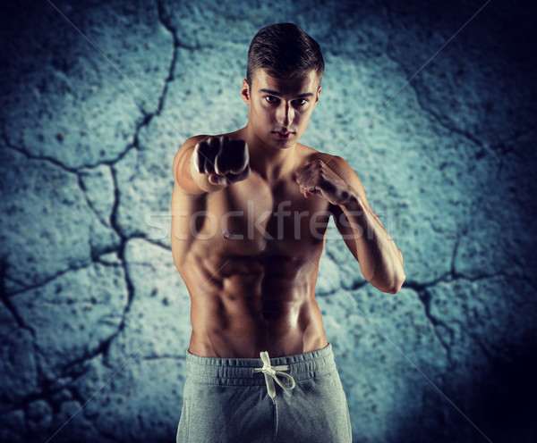 young man in fighting or boxing position Stock photo © dolgachov