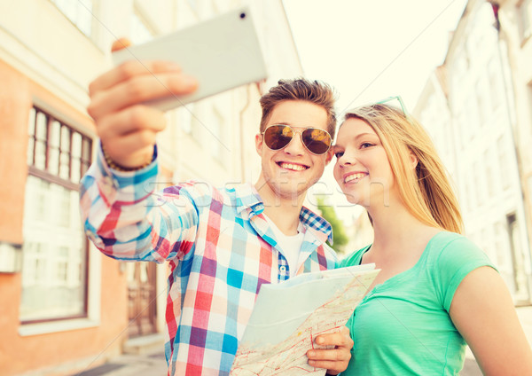 smiling couple with smartphone in city Stock photo © dolgachov