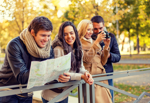 Stock photo: group of friends with map and camera outdoors