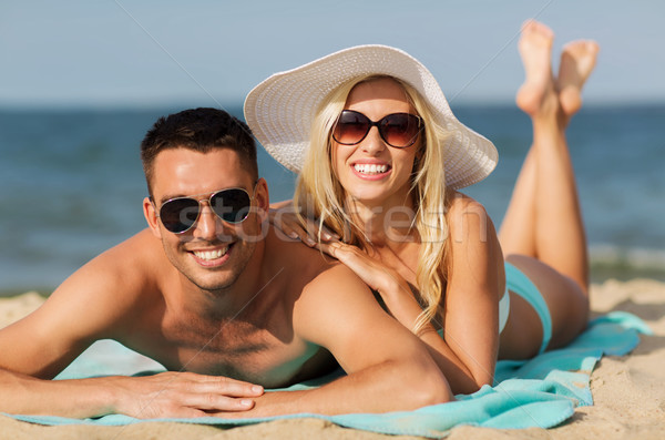 happy couple in swimwear lying on summer beach Stock photo © dolgachov