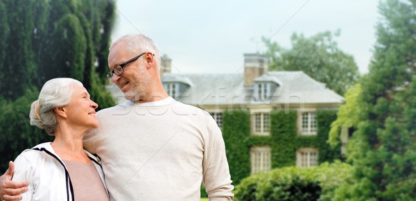 senior couple hugging over living house background Stock photo © dolgachov