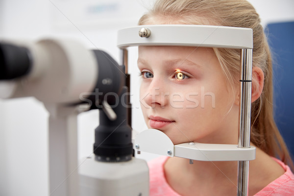 girl checking vision with tonometer at eye clinic Stock photo © dolgachov