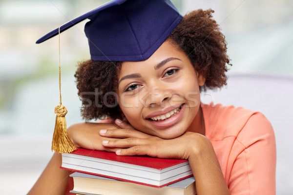 Stock photo: happy african bachelor girl with books at home