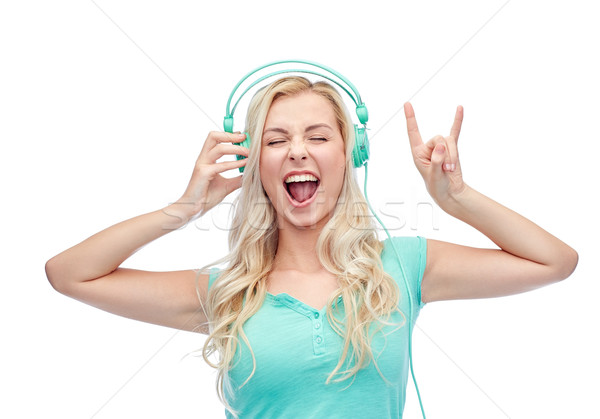 Heureux jeune femme adolescente casque musique technologie [[stock_photo]] © dolgachov