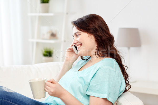 plus size woman calling on smartphone at home Stock photo © dolgachov