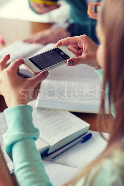 student hands with smartphone making cheat sheet Stock photo © dolgachov