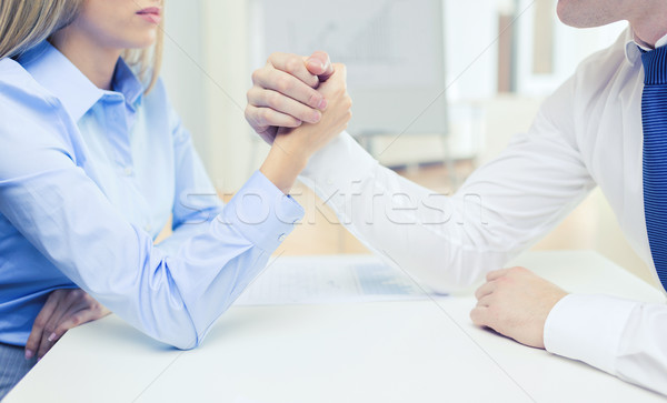 businesswoman and businessman arm wrestling Stock photo © dolgachov