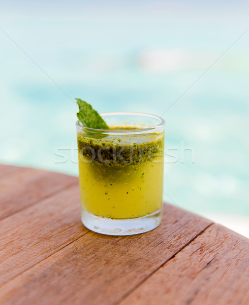 Stock photo: glass of fresh juice or cocktail on table at beach