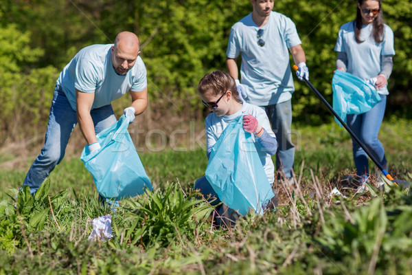 Stock photo: volunteers with garbage bags cleaning park area