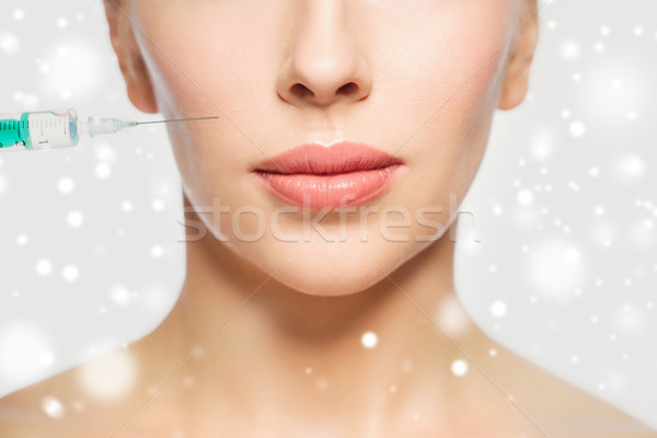 close up of woman face and syringe needle Stock photo © dolgachov