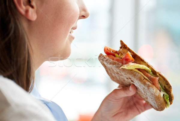 Közelkép boldog nő eszik panini szendvics Stock fotó © dolgachov